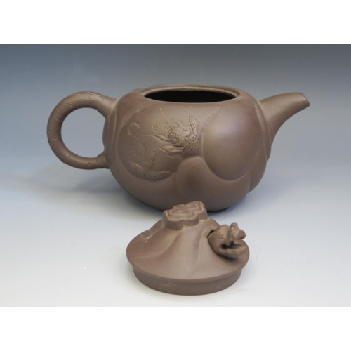 1667 - A Chinese Yixing pottery teapot, of squat circular form, decorated with dragons amongst clouds, the ... 