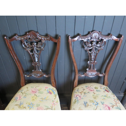 1685 - A pair of late Victorian salon chairs, with pierced and scroll backs, stuff-over seats raised on cab... 