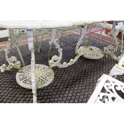 1688A - A painted metal garden set, comprising an oval table with pierced scroll decoration raised on scroll... 