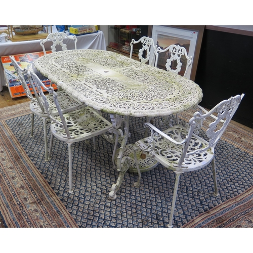 1688A - A painted metal garden set, comprising an oval table with pierced scroll decoration raised on scroll... 