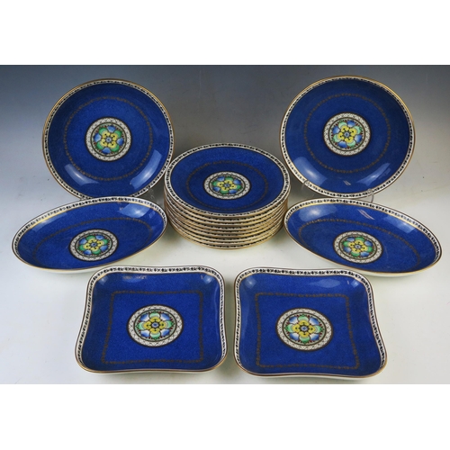 1884 - A Wedgwood part dinner service, with central gilded medallion to a mottled blue ground.