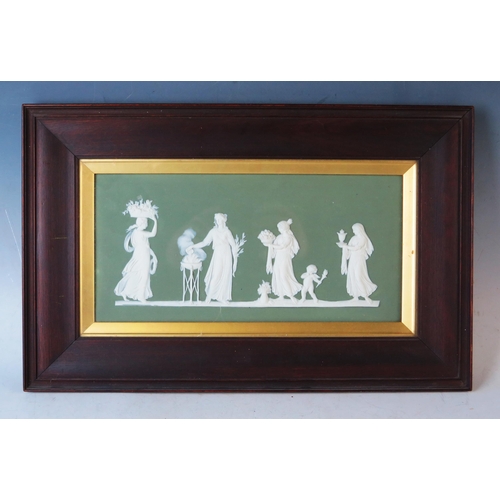 1894 - A Wedgwood Jasperware plaque, decorated with neo-classical maidens to a green ground, contained in a... 