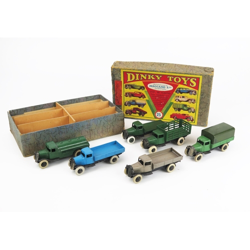 Dinky Pre-War 25 Commercial Motor Vehicles Set contained in 1st Series "Dinky Toys" grey marble style box containing 6x 25 Series Lorries all with type 2 black chassis - (1) 25a Wagon in blue with black smooth hubs, (2) 25b Covered Wagon in green, military green tilt, smooth black hubs, (3) 25c Flat Truck in dark green with dark green smooth hubs, (4) 25d Petrol Tank Wagon in dark green, "PETROL" in black, smooth black hubs, (5) 25e Tipping Wagon in stone, smooth black hubs, (6) 25f Market Gardeners Lorry in dark green with smooth black hubs - good to excellent, 2 or 3 have replacement tyres, one wheel comes loose to 25f, 25c has fatigue to hubs (4 models have thin axles, 2 have thick  axles) - the box is an amazing survivor being a grey marble print from 1937 in line with the change to the type 2 chassis models with "Meccano Co of America 200 - 5th Avenue - New York" label which is very rare to find,  yellow "Commercial Motor Vehicles 25" to end. The box retains bright vibrant colours to the labels but does have some wear, most corners have torn but have been considerately repaired, card divider quite likely to be a replacement. A very seldom seen set.