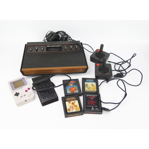 2643 - Atari Video Computer System with 2 joystick controllers, video-touch pad and 4 games together with a... 