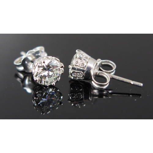 703 - A Pair of Diamond Stud Earrings, 18ct white gold clips stamped 750, EDW 1.5ct, 2.8g