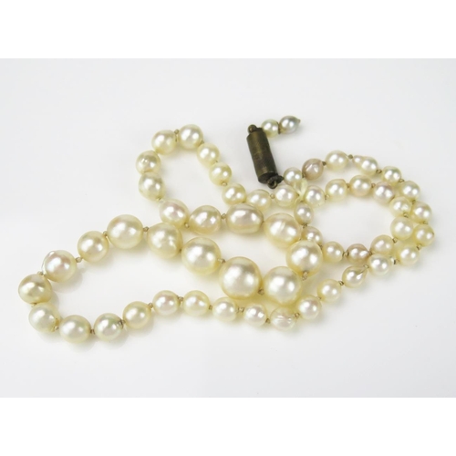 802 - A String of Graduated Misshapen Pearls, largest pearl 8mm approximately, knotted, base metal clasp, ... 