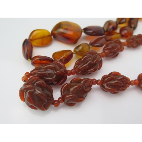 893 - A Chinese Carved Agate Bead Necklace, together with a natural amber necklace, (2).