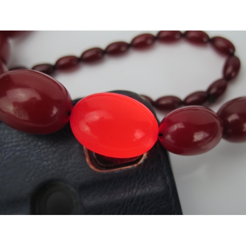 894 - A Very Long Graduated Cherry Faux Amber Bead Necklace, largest bead 30x21mm, no clasp, 1360mm approx... 