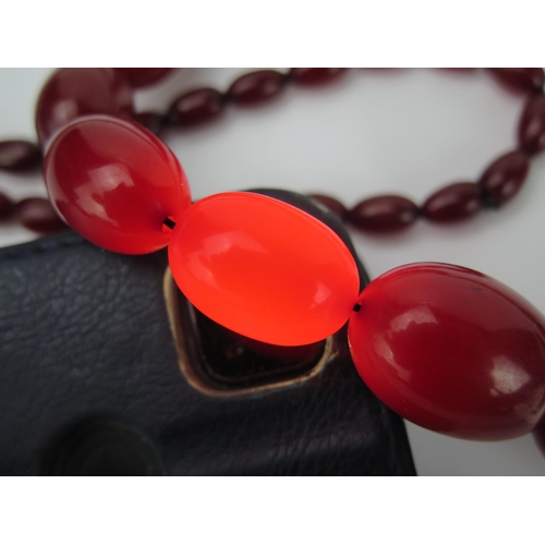 894 - A Very Long Graduated Cherry Faux Amber Bead Necklace, largest bead 30x21mm, no clasp, 1360mm approx... 