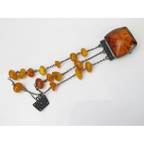 898 - A Russian Silver and Amber Cloak Pin, the large natural stone 26x24mm, set in marked silver post 195... 