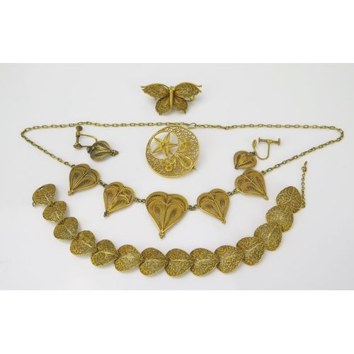 905 - A Gilt Metal Egyptian Suite, comprising of necklace, bracelet, butterfly brooch, earring drops and c... 