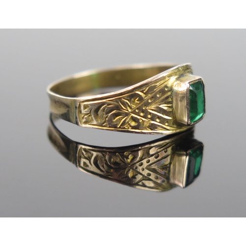 943 - A 19th Century Unmarked Yellow Metal and Green Paste Ring with chased decoration, size J, 1.3g