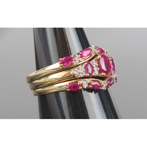 945 - A Modern Ruby, Diamond and Gold Trio/Trinity Ring, the central ring with oval stone 6x4.2mm, flanked... 