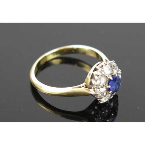 955 - A Sapphire and Diamond Cluster Ring, central stone 5mm diameter, surround by eleven small diamonds, ... 