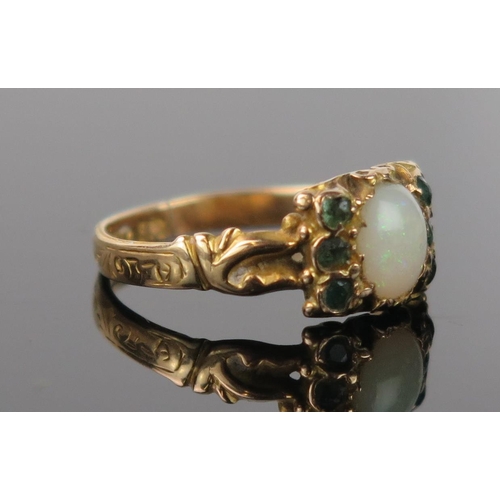 975 - An Antique Opal, Greenstone and 15ct Gold Ring, the central oval stone red/green flashes, decoration... 