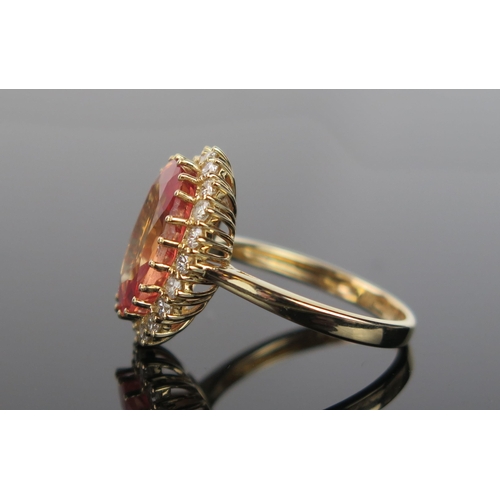 982 - A Mandarin or Orange Sapphire, Diamond and 14ct Gold Cocktail Ring, the pinkish orange central stone... 