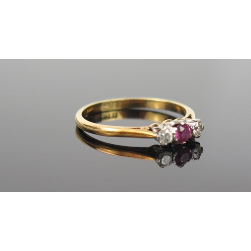 984 - A Ruby, Diamond and 18ct Gold Ring, the pale ruby flanked by two diamonds, size L.5, 2g