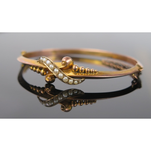 991 - An Edwardian 9ct Gold and Seed Pearl Bangle, 5g approximately, 6.5cm diameter (untested).