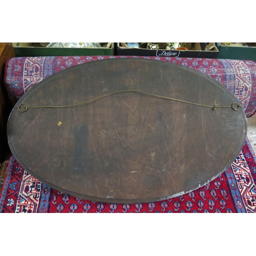 1682C - An oval advertising mirror 'Gallaher's Rich Dark Honeydew' contained in a mahogany frame 76cm wide.