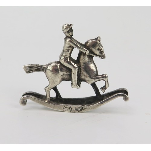 1170A - A Continental silver novelty miniature rocking horse and rider, bears import marks for Singleton Ben... 