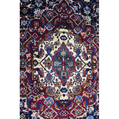 1336 - A Persian Mood carpet, with central field with ivory and wine red pole medallion and all over flower... 