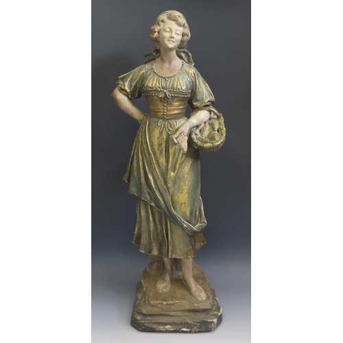 1253 - A large late 19th century French terracotta figure of a female fish seller, wearing a head scarf and... 