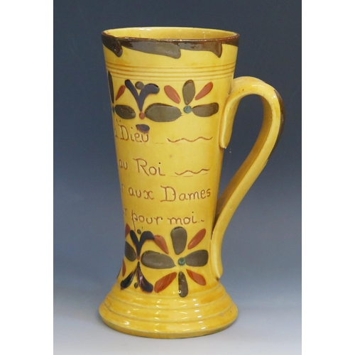 1255 - A Torquay pottery twin handled mug, inscribed with flowerhead Kerswell Daisy decoration (French mott... 