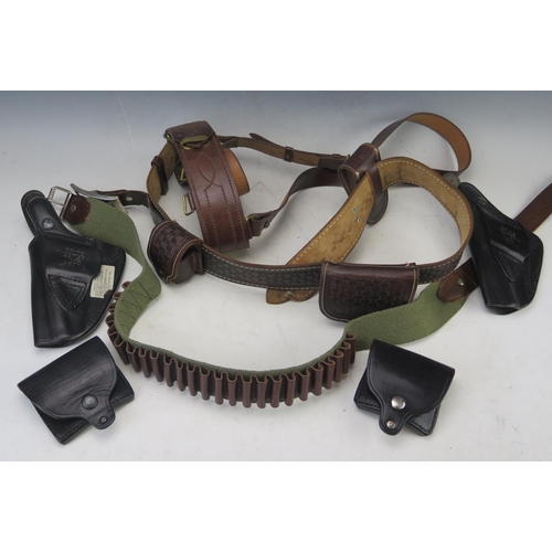 1008 - A reproduction stitched leather 'Sam Brown' bet, a canvas cartridge belt, a stitched leather gun bel... 