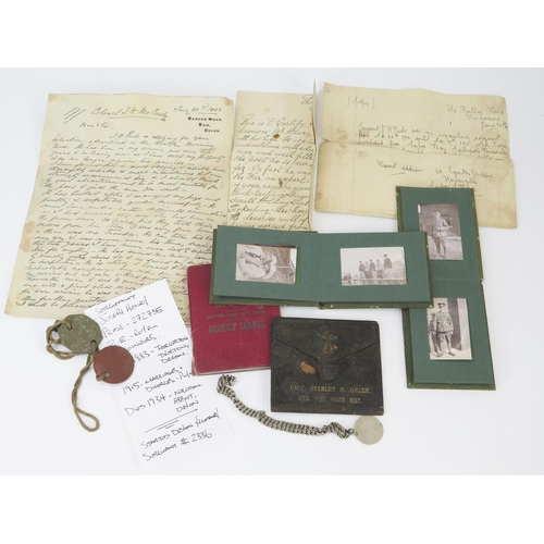 1018A - A small collection of military ephemera, including photographs, identity tags, driving licence