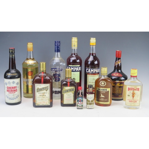 1027 - A collection of assorted spirits and liqueurs including, Cherry Heering Liqueur, Campari, Vodka, Coi... 