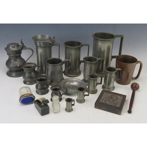 1030 - A collection of continental pewter measures, flagon, mugs, printers block, etc