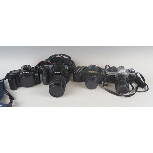 1042A - A collection of assorted 35mm SLR camera and camera equipment including A Canon EOS 1000 camera, Can... 