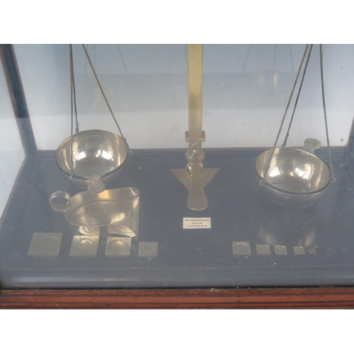 1072B - De Grave & Co, London, a pair of lacquered brass laboratory balance scales, with part set of weights... 