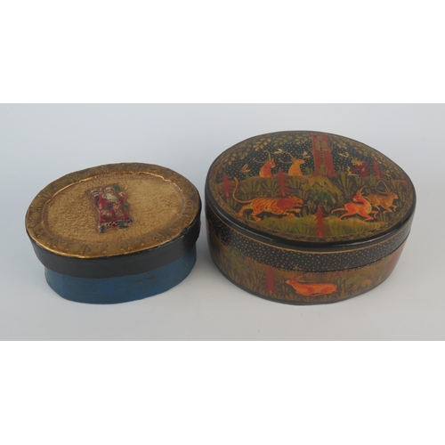 1078 - A Kashmir papier mache and lacquered oval box and cover, the lid decorated with a hunting scene, the... 