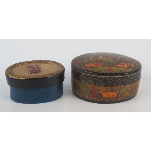 1078 - A Kashmir papier mache and lacquered oval box and cover, the lid decorated with a hunting scene, the... 