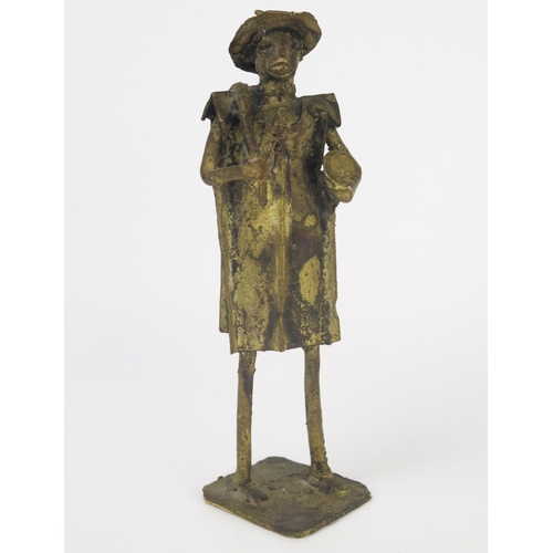 1079A - A Benin bronze figure of a standing man holding a drum and beater, on square base, 22cm high