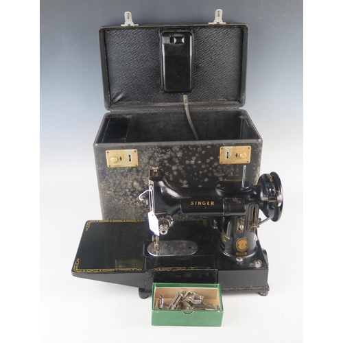 1085 - An early portable electric Singer sewing machine, model 222K1, in original box with accessories