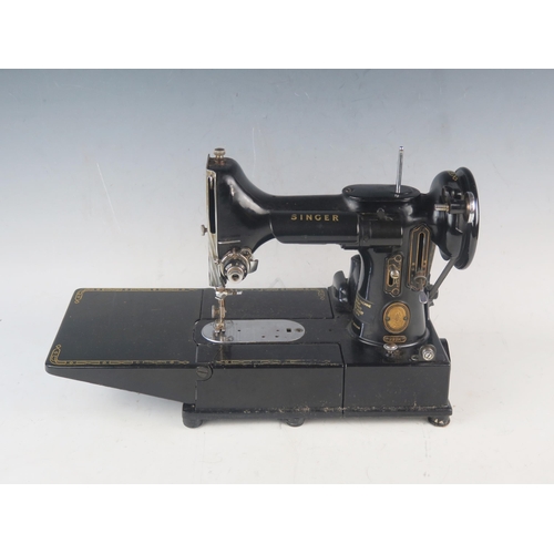 1085 - An early portable electric Singer sewing machine, model 222K1, in original box with accessories