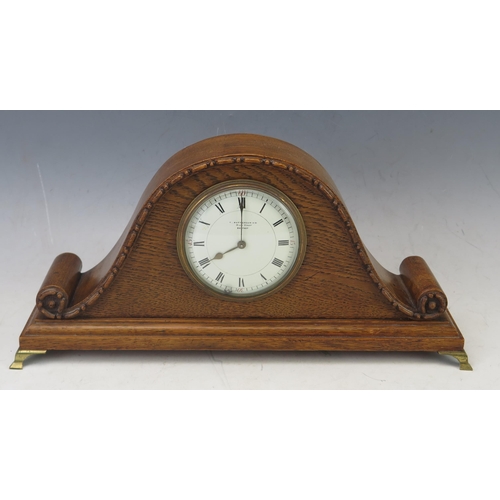 1111 - A 1920's oak mantel timepiece of arched outline, with 8.5cm Roman dial, the movement with lever plat... 