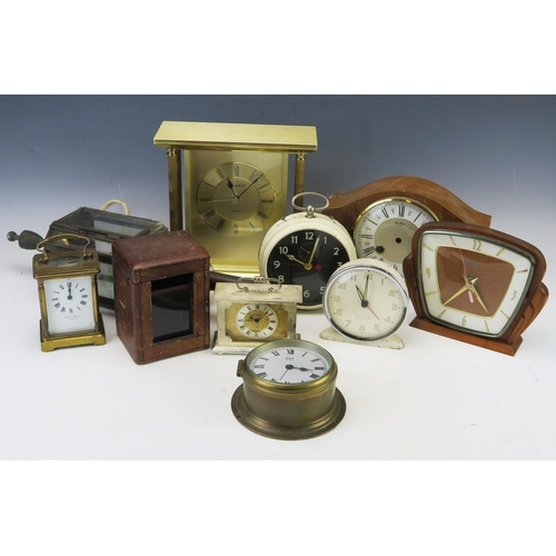 1113 - A collection of assorted timepieces, including alarm clock, miniature bulkhead clock, carriage timep... 