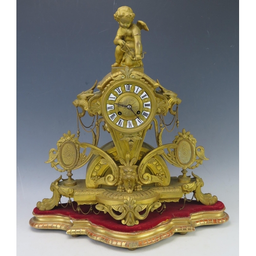 1118 - A 19th Century French gilt metal figural mantel clock, the arched and tapering case, surmounted by C... 