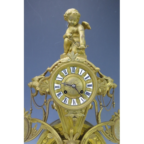 1118 - A 19th Century French gilt metal figural mantel clock, the arched and tapering case, surmounted by C... 