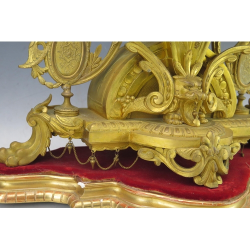 1118 - A 19th Century French gilt metal figural mantel clock, the arched and tapering case, surmounted by C... 