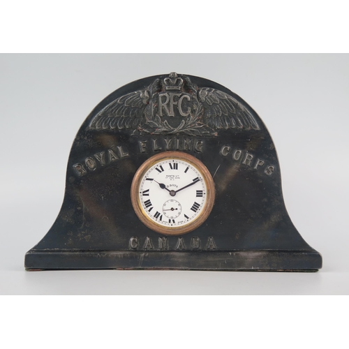 1135 - A World War I period metal mantel timepiece, of arched outline, the case with RFC logo and inscribed... 