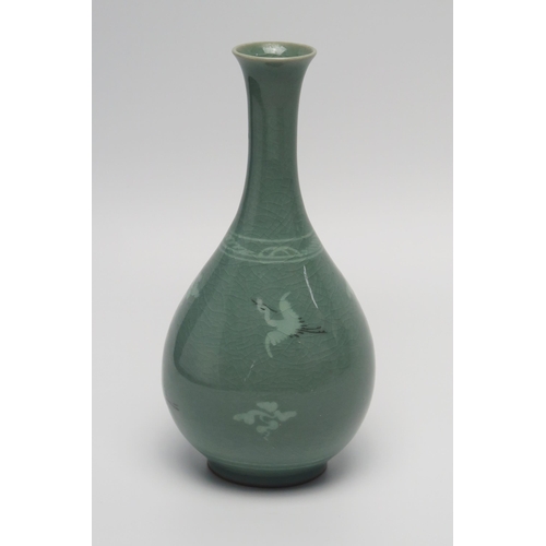 1160 - A Korean bottle vase, decorated with cranes amongst clouds to a celadon ground, bears signature to t... 