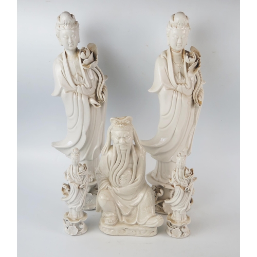 1163 - A large Chinese blanc-de-chine figure of Guan Yin, in traditional robes holding a lotus flower, 38.5... 