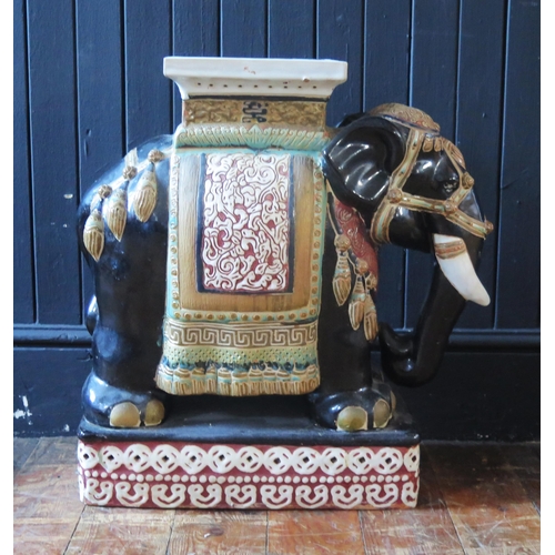 1169 - A large Chinese pottery jardinière stand, modelled in the form of an elephant, with polychrome decor... 