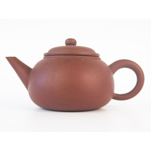 1173 - A Chinese Yixing teapot, of plain circular form with domed cover, impressed four character mark to t... 