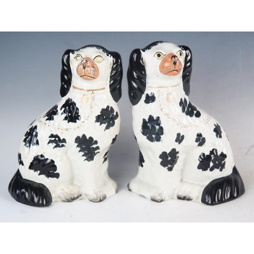 1234 - A pair of Staffordshire King Charles spaniels, with polychrome decoration, 25.5cm high.