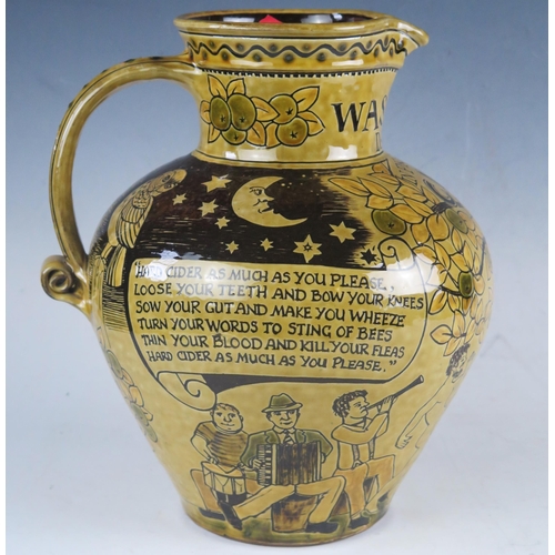 1236 - A 20th century pottery Wassail jug, with incised decoration of figures dancing around an apple tree,... 